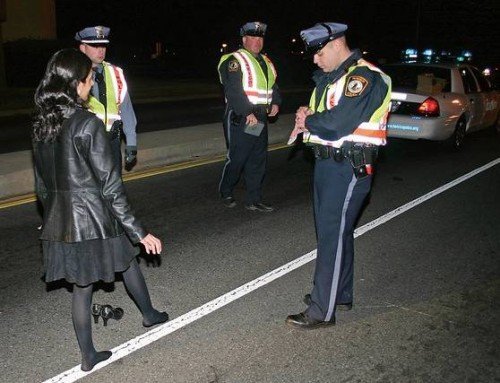 Here the roadway is relatively dry, hard, and level. Notice the woman's high heel shoes have been removed.