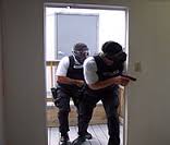 A DEA training photo on entering a home.