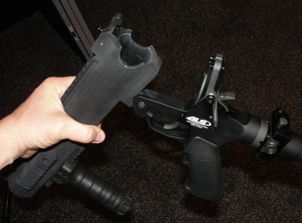 The breech break-open feature is activated by an ambidextrous silver lever just behind and above the trigger group.