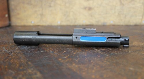 The UTM AR-15 bolt. The French blue marking is clearly visible from the ejection port.