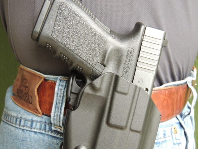 The GLS is positioned to be engaged by the user's middle finger upon proper grip.