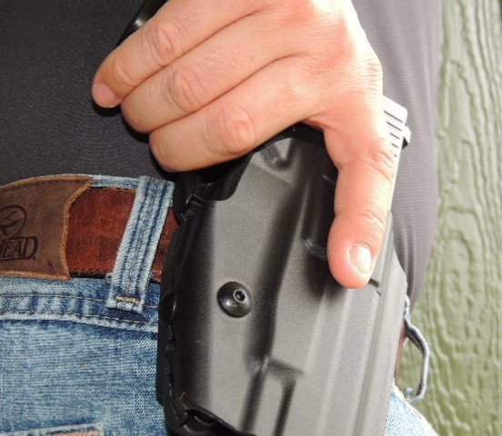 As the shooter begins to grip the pistol, the middle finger intuitively engages the GLS locking lever.