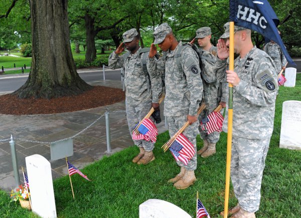 US Army soldiers placing flags at Arlington Cemetery. Photo by U.S. Military.