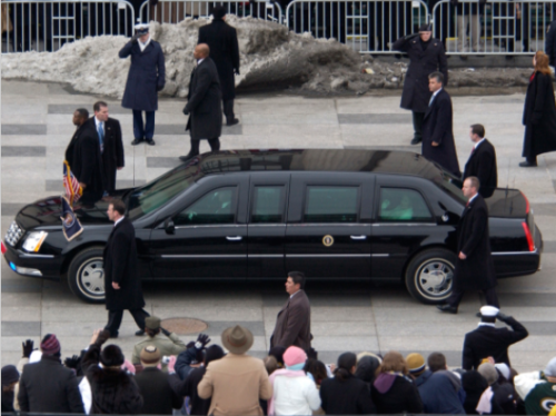 The trench coats are obvious, but there is a SWAT team nearby watching. (photo by US Secret Service)