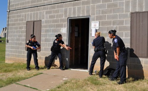 Uniformed SWAT officers making entry as a Sweep Team fulfills legal requirements and safety needs. (photo by sapdexplorers.com)