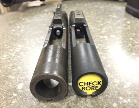 A comparison of the live-fire bolt (left), and the UTM CTA bolt (right). Notice the offset firing pin on the UTM bolt for rimfire.