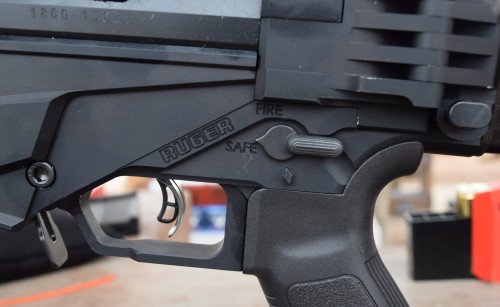 The AR-style safety lever only requires a 45-degree movement, which is beneficial to LE snipers. Note the magazine release lever to the left, the trigger, and the stock release button on the right.