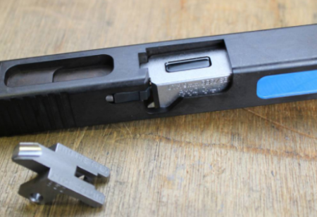 Here a special cut-away Glock barrel shows how the UTM conversion kit fits - note the same bright blue indicator for safety.