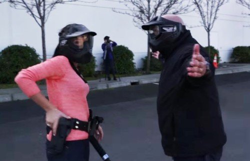 Appropriate force is not always clear, as seen by this civilian in police training grabbing her gun on an armed suspect (photo from YouTube.com)