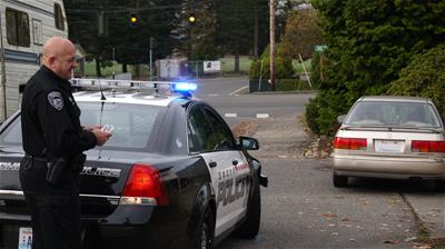 Going around the rear of the patrol car gives plenty of observation time during a passenger side approach (photo by Snohomish, WA Police).