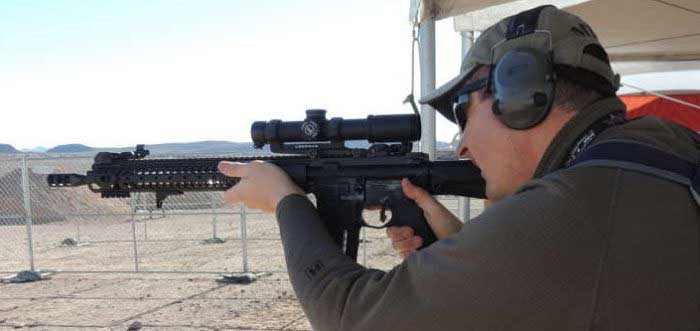 Author Shooting an AR-15 with a 1-4x Magnification Scope